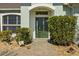 Inviting front entrance with a green door and landscaped walkway at 176 Brookshire Dr, Lake Wales, FL 33898