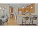 Bright kitchen with an island, wood cabinets, and breakfast bar at 176 Brookshire Dr, Lake Wales, FL 33898