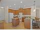 Kitchen with island, wood cabinets and breakfast bar at 176 Brookshire Dr, Lake Wales, FL 33898