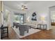 Bright living room with hardwood floors, comfy seating, and a view of the pool at 176 Brookshire Dr, Lake Wales, FL 33898