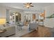 Open concept living room with hardwood floors and views of the kitchen and pool at 176 Brookshire Dr, Lake Wales, FL 33898