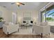 Spacious living room with comfy seating, large windows, and access to a patio at 176 Brookshire Dr, Lake Wales, FL 33898