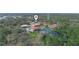 Aerial view showcasing the community, pond, and lush landscaping at 2002 Granada Ct # 1, Lake Wales, FL 33898