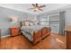 Comfortable main bedroom with a ornate wooden bed frame, neutral decor, and plenty of natural light at 2002 Granada Ct # 1, Lake Wales, FL 33898