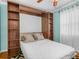 Comfortable bedroom featuring a murphy bed with built-in shelving at 2002 Granada Ct # 1, Lake Wales, FL 33898