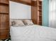 Comfortable bedroom featuring a murphy bed with built-in shelving at 2002 Granada Ct # 1, Lake Wales, FL 33898