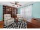 Comfortable bedroom featuring two recliner chairs and large built-in shelving at 2002 Granada Ct # 1, Lake Wales, FL 33898