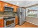Well-equipped kitchen featuring stainless steel appliances and wood cabinets at 2002 Granada Ct # 1, Lake Wales, FL 33898