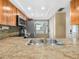 Kitchen view showcasing stainless steel sink, granite counters, and tiled backsplash at 2002 Granada Ct # 1, Lake Wales, FL 33898