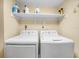 Well-equipped laundry room with a washer, dryer, and utility shelving at 2002 Granada Ct # 1, Lake Wales, FL 33898