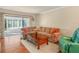 Cozy living room with a plush sectional sofa, warm wood floors, and sliding doors at 2002 Granada Ct # 1, Lake Wales, FL 33898