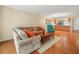 Open concept living room featuring wood floors, a comfortable sofa, and an open view into the kitchen at 2002 Granada Ct # 1, Lake Wales, FL 33898