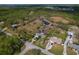 Aerial view of a landscaped property with a pond and surrounding trees at 208 Limpkin Ln, Frostproof, FL 33843