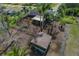 Aerial view of backyard with spacious shed, fence, greenery, palm trees, and convenient main street access at 208 Limpkin Ln, Frostproof, FL 33843