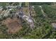 Aerial view of a large lot with a pond and surrounding trees at 208 Limpkin Ln, Frostproof, FL 33843