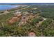 Expansive aerial view of a beautiful home surrounded by lush greenery and highlighting property lines at 208 Limpkin Ln, Frostproof, FL 33843