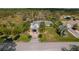 Aerial view of a house and surrounding property with a pond nearby at 208 Limpkin Ln, Frostproof, FL 33843