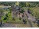 Backyard aerial view of land featuring fence, trees, and convenient access to the main road at 208 Limpkin Ln, Frostproof, FL 33843