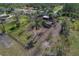 Aerial view of a fenced pasture area with a barn and sheds at 208 Limpkin Ln, Frostproof, FL 33843