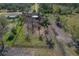 Aerial view of a rustic barn, pasture, and surrounding trees at 208 Limpkin Ln, Frostproof, FL 33843