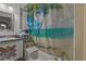Bathroom featuring custom tile, a decorated vanity and a beach themed shower curtain at 208 Limpkin Ln, Frostproof, FL 33843