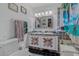 Colorful bathroom with double vanity and patterned tile at 208 Limpkin Ln, Frostproof, FL 33843