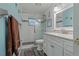 Modern bathroom features white vanity, framed mirror, and glass shower with decorative tile accents at 208 Limpkin Ln, Frostproof, FL 33843