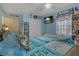 Well-lit bedroom with a ceiling fan, plush bedding, and a full closet at 208 Limpkin Ln, Frostproof, FL 33843
