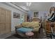 Bedroom with wooden furniture, carpet, and exercise bike at 208 Limpkin Ln, Frostproof, FL 33843