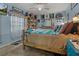 Comfortable bedroom with a ceiling fan, plush bedding and decor at 208 Limpkin Ln, Frostproof, FL 33843