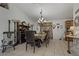 Dining room featuring an elegant chandelier, rustic wood accents, and a stylish table setting at 208 Limpkin Ln, Frostproof, FL 33843