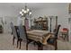 The dining area features a dark wood table set with a decorative hutch and chandelier at 208 Limpkin Ln, Frostproof, FL 33843