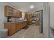 Well-lit kitchen featuring wooden cabinetry, stainless steel appliances, and tiled flooring at 208 Limpkin Ln, Frostproof, FL 33843