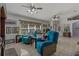 Cozy living room featuring two teal armchairs and a large window at 208 Limpkin Ln, Frostproof, FL 33843