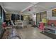 Bright sunroom with tile flooring, wicker seating, and natural light at 208 Limpkin Ln, Frostproof, FL 33843