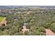 Aerial view of a house nestled among lush green trees and a large property at 21113 Kissimmee Shores Rd, Lake Wales, FL 33898