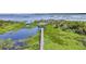 Aerial view of a wooden dock extending over a calm lake, surrounded by lush vegetation at 21113 Kissimmee Shores Rd, Lake Wales, FL 33898