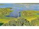 Picturesque aerial scene of lake with a dock amid dense vegetation and serene blue waters at 21113 Kissimmee Shores Rd, Lake Wales, FL 33898