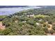 Aerial view showing home, outbuildings, and expansive waterfront property at 21113 Kissimmee Shores Rd, Lake Wales, FL 33898