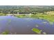 Beautiful lakefront acreage features lush greenery, dock, and serene water views at 21113 Kissimmee Shores Rd, Lake Wales, FL 33898