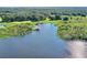 Aerial view of a scenic lake showcasing a private boat dock and lush green surroundings at 21113 Kissimmee Shores Rd, Lake Wales, FL 33898