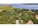 Aerial view showcasing home, detached garage, and waterfront access at 21113 Kissimmee Shores Rd, Lake Wales, FL 33898