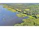 Wide aerial shot displaying a lakeside estate with private docks and verdant landscape at 21113 Kissimmee Shores Rd, Lake Wales, FL 33898