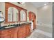 Elegant bathroom with double vanity, granite countertop, and a soaking tub at 21113 Kissimmee Shores Rd, Lake Wales, FL 33898