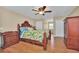 Bright bedroom featuring wood flooring and a wooden bed frame at 21113 Kissimmee Shores Rd, Lake Wales, FL 33898