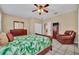 Comfortable bedroom with a wooden bed frame and tiled floors at 21113 Kissimmee Shores Rd, Lake Wales, FL 33898