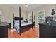 Spacious bedroom with wood flooring and a large four-poster bed at 21113 Kissimmee Shores Rd, Lake Wales, FL 33898