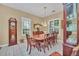 Bright dining room featuring a large wood table and chairs, hardwood floors and large windows at 21113 Kissimmee Shores Rd, Lake Wales, FL 33898