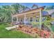 House exterior showcasing a wraparound porch and well-manicured lawn at 21113 Kissimmee Shores Rd, Lake Wales, FL 33898
