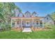 Two-story house with a wraparound porch and landscaped yard at 21113 Kissimmee Shores Rd, Lake Wales, FL 33898